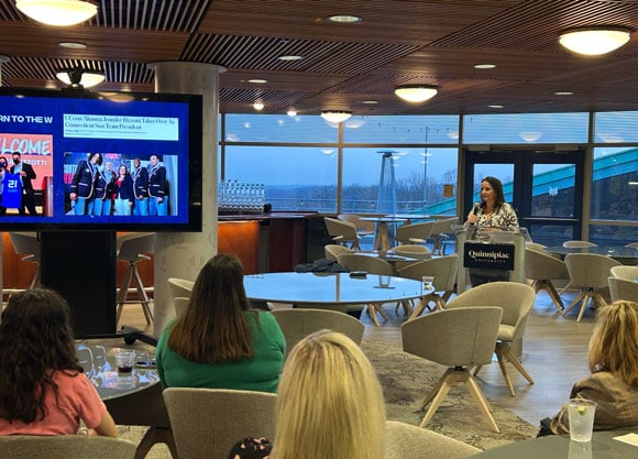 Jen Rizzotti speaks in front of crowd.