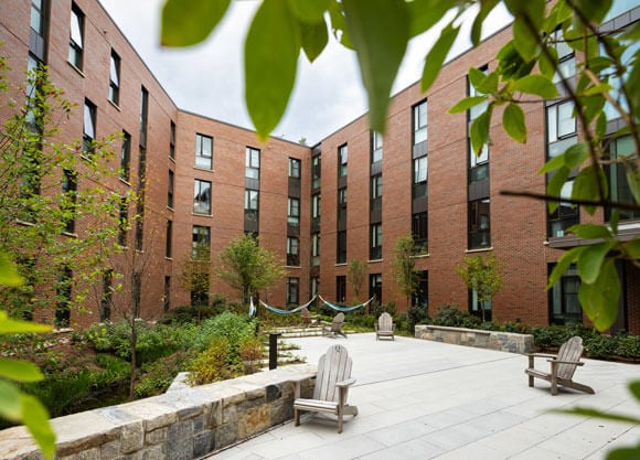 Lush trees fill a courtyard at The Grove residences