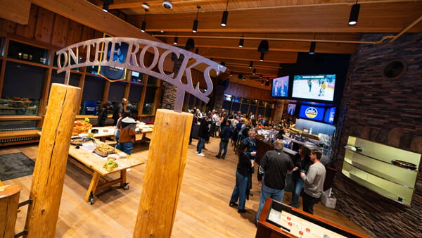 Large groups of people conversing at Quinnipiac's On the Rocks venue space